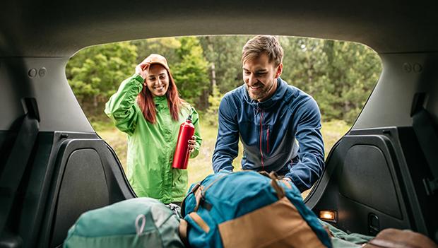 Unloading gear and supplies for a car camping trip.